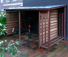 a bicycle is parked in the garage with its door open to let people know what's inside