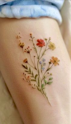 a woman's thigh with flowers on it