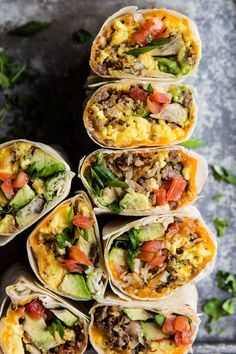 breakfast burritos are stacked on top of each other and ready to be eaten