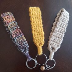 three crocheted key fobs on a table