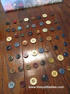 a wooden table topped with lots of buttons