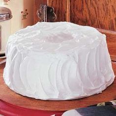 a white cake sitting on top of a wooden table