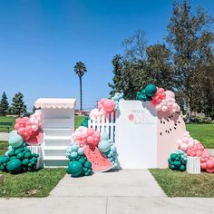 an outdoor party setup with balloons and decorations