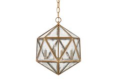 a hanging light fixture with three candles inside the glass and gold metal frame, on a white background