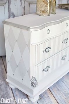 a white dresser sitting on top of a wooden floor