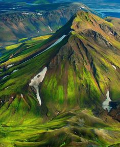 an aerial view of the green mountains and lakes in iceland's faroen