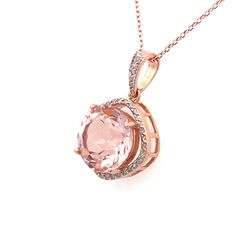 "Early 21st Century Estate 14kt rose gold halo style pendant necklace. The pendant features a prong set morganite beryl with a surrounding cushion shaped halo frame and tapered bail pave' set with diamonds.  The pendant is suspended on a 14kt rose gold fine cable link necklace chain with a lobster claw clasp.  Gemstone: 1 round mixed cut morganite, 5.0 carats total weight (calculated in mounting) light tone orangy-pink color Gemstones: 38 round single cut diamonds, 0.19 carats total weight (calc Luxury Pink Round Pendant Jewelry, Luxury Pendant Necklaces With Rose Cut Diamonds, Pink Gold Pendant Necklace With Gemstone, Morganite Necklace Pendants, Pink Faceted Pendant, Rose Gold Halo, Halo Pendant, Pink Morganite, Gold Halo