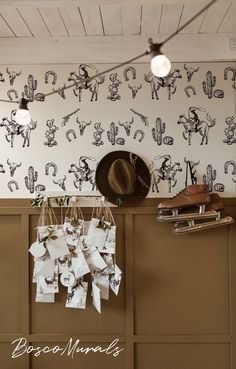 there are many pictures hanging on the wall with hats and paper notes attached to them