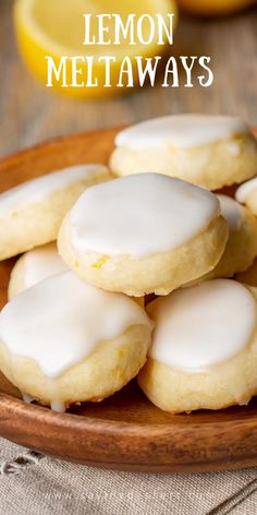 lemon cookies with white icing on a wooden plate