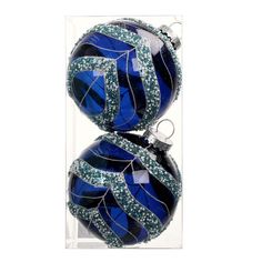 two blue and green ornaments in a clear box with silver trimmings on them