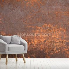 a chair sitting in front of a rusted wall