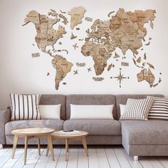 a living room with a couch, table and large wall map on it's wall