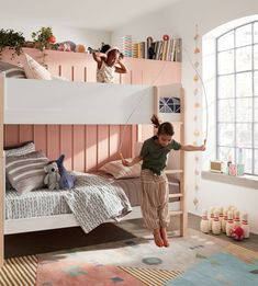 two children are playing on the bunk beds