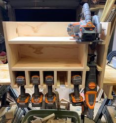 a group of drillers sitting on top of a wooden shelf