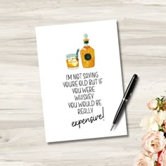 a greeting card with an image of a bottle of liquor and flowers on the table