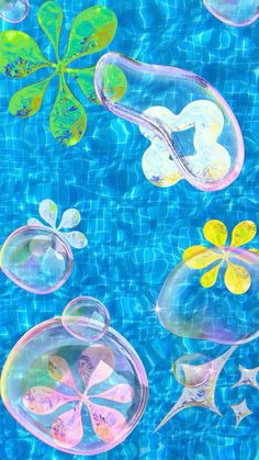 some bubbles floating in the water with leaves and flowers