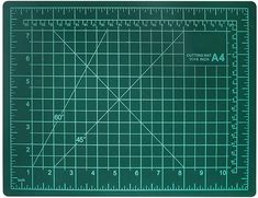 a green cutting mat with a ruler on it