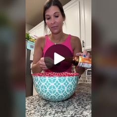 a woman is pouring something into a bowl