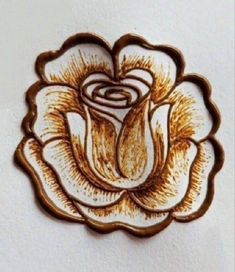 a drawing of a rose on a white wall in the shape of a flower with swirls