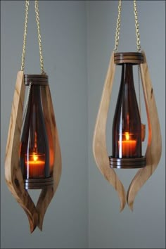 two hanging candles with chains attached to them, one is brown and the other is orange