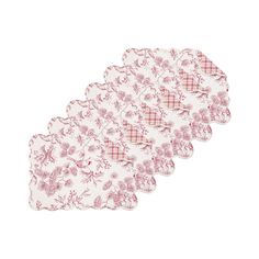 four pink and white placemats with flowers on them