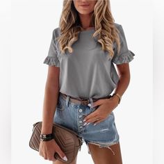 This Takes A T-Shirt To A Whole New Level. This Is So Pretty. It Is A Lovely Gray Color With Ruffle Sleeves. It Can Be Worn With Shorts, Jeans Or Paired With A Skirt. The Ruffled Sleeve Makes It Very Versatile And Can Even Be Worn To Work. It Is A Size M. It Has Never Been Worn And Had Been Kept In A Very Clean Non-Smoking Home. Casual Cotton Ruffle Sleeve Top, Casual Cotton Short Sleeve Top With Ruffle, Casual Cotton Short Sleeve Top With Ruffle Sleeve, Solid Color T-shirt With Ruffle Sleeves For Spring, Casual Ruffle Sleeve T-shirt For Summer, Casual Summer T-shirt With Ruffle Sleeves, Summer Solid Color Tops With Ruffle Sleeves, Summer Tops With Ruffle Sleeves In Solid Color, Summer Ruffle Sleeve Tops In Solid Colors