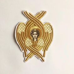 Gold embroidered Angel Cherubim.  This Seraphim Applique can be used as embellishment to Bible, Prayer books, Bible Gospel bookmarks, Holy table covers, Vestments or Any Altar Cloths.  Can be embroidered gold or silver metallic threads on the liturgical color ultra-suede. Price for 1 applique. Measurements: 9 cm width x 12 cm height Traditional Gold Machine Embroidered Fabric, Traditional Gold Embroidered Fabric With Machine Embroidery, Bible Gospel, Prayer Books, Orthodox Priest, Liturgical Colours, Altar Cloth, Satin Flowers, Prayer Book