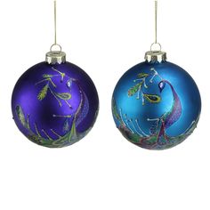 two blue christmas ornaments hanging from strings