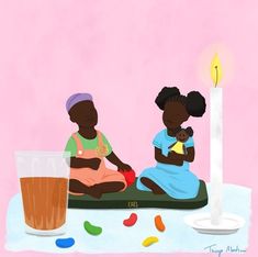 two children are sitting on the floor next to a candle