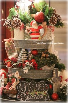 a christmas tree with ornaments and decorations on it's sides, including pine cones