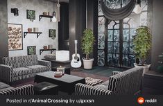 the living room is decorated with black and white striped furniture, potted plants, and pictures on the wall