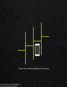 a cell phone sitting on top of a black surface with yellow lines in the middle