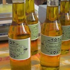 four bottles of oil sitting on top of a table