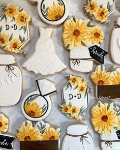 decorated cookies with sunflowers and bride's names on them are displayed for sale