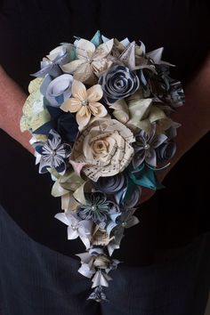 a woman holding a bouquet of paper flowers