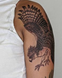 an eagle tattoo on the arm and shoulder