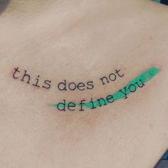 a person with a tattoo on their chest that says, this does not define you