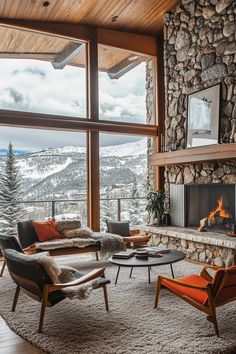 a living room filled with furniture and a fire place in front of a large window