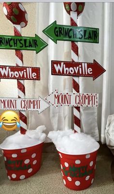 two buckets filled with snow and directional signs