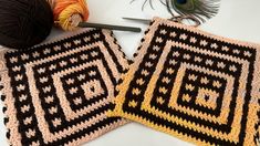 two crocheted squares sitting on top of each other next to a ball of yarn