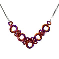 Vivid orange, red and violet create a fiery color combination that is bold and bright. Made of lightweight aluminum, the necklace is extremely comfortable to wear. Length of necklaces worn in photos is 16". view size guide Anodized Aluminum with stainless steel chain and lobster claw clasp. SUNSET colorway - orange, red, violet Vibrant Orange Necklace For Gift, Red And Violet, V Necklace, Small Necklace, Red Violet, Lobster Claws, Anodized Aluminum, Steel Chain, Stainless Steel Chain