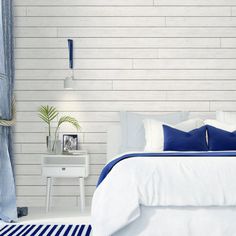 a bedroom with white walls and blue accents