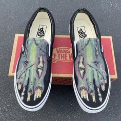 Whether you're dressing up for Halloween or want to get in the spooky spirit, these zombie feet slip-on vans are for you. Custom designed these shoes feature the decaying zombie feet including all the gross things you might find on a zombie. We buy each pair of shoes BRAND NEW. Each pair is made to order, please make sure you put in the correct shoe size before you check out.  The paint is permanent and will never come off, fade away, or peel off. Made in the USA. This price includes everything: Skeleton Shoes, Custom Slip On Vans, Hand Painted Vans, Wedding Vans, Painted Objects, Gross Things, Bright Sneakers, Trash Fashion, Customized Shoes