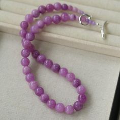 Embrace the essence of spring and summer with our Lavender Grapevine Gemstone Beaded Necklace! The enchanting purple hue exudes a blend of dreaminess and a hint of mystery. Crafted with romantic healing lavender gemstones delicately strung together, complemented by a minimalist OT clasp, this necklace embodies gentle elegance with a touch of individuality. Perfectly versatile, it effortlessly elevates any ensemble, whether paired with a solid-colored tee or a breezy resort sundress, exuding a charming Southern French allure. Metal: Recycled Sterling Silver Plated On Brass Gemstone: Natural Stone 10mm Length: 480mm Weight: 60g Purple Single Strand Beaded Necklace Gift, Purple Single Strand Beaded Necklace For Gift, Gift Purple Single Strand Beaded Necklace, Lavender Amethyst Gemstone Beaded Necklace, Elegant Amethyst Beaded Necklaces For Healing, Elegant Adjustable Purple Beaded Necklaces, Elegant Amethyst Beaded Necklace For Healing, Lavender Spiritual Necklaces With Natural Stones, Spiritual Lavender Gemstone Bead Necklace