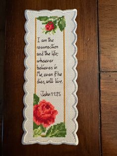 a cross stitch bookmark with a rose on it and the words, i am the reason