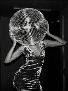 a woman with a disco ball on her head