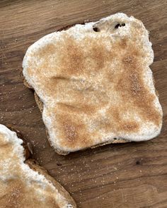 two pieces of bread sitting on top of a wooden table