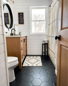 a bathroom with black and white tile flooring