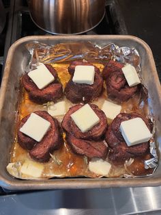 some food is sitting in a pan on top of the stove and ready to be cooked