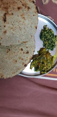 there is a plate with some food on it and broccoli next to it